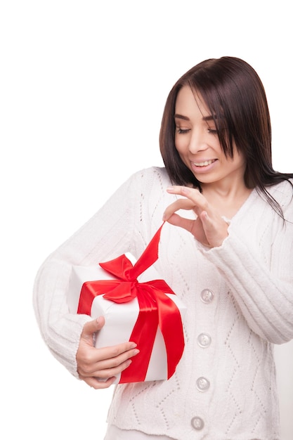 Schönes junges Weihnachtsmädchen mit einem Geschenk getrennt auf weißem Hintergrund