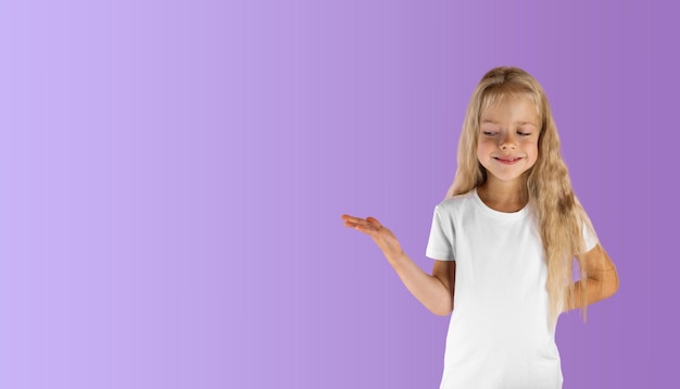Schönes Mädchen in einem weißen T-Shirt auf lavendelfarbenem Hintergrund Kopierraum für horizontale Ausrichtung