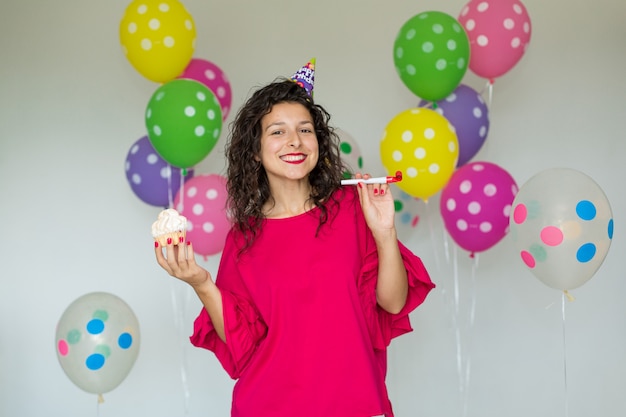 Schönes nettes freundliches Mädchen mit farbigen Ballonen