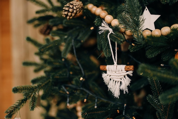 Schönes Weihnachtsspielzeug auf einem Weihnachtsbaum mit Makramee-Nahaufnahme