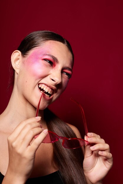 Schönheit Mode weibliche rosa Brille helles Make-up posiert schwarzen Jersey rosa Hintergrund unverändert