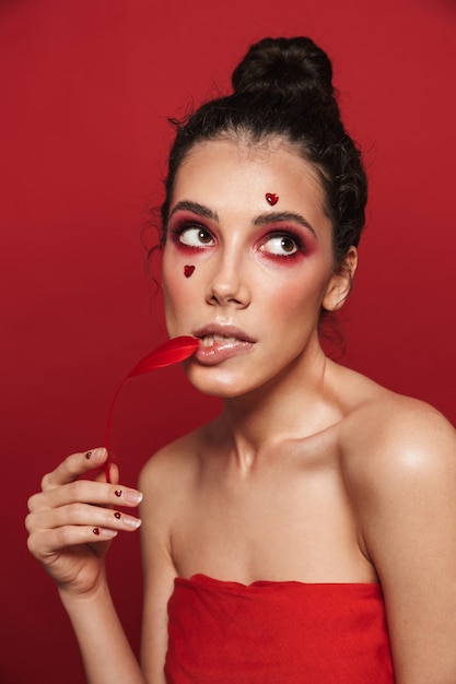 Schönheitsporträt einer attraktiven jungen toplessen Frau, die Make-up steht, isoliert