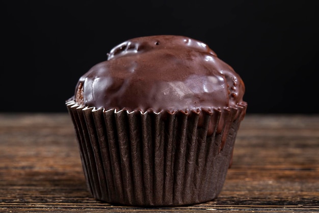 Schokoladen-Cupcake in schwarzer Papierverpackung