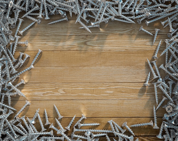 Schrauben, die einen Rahmen um eine Holzoberfläche bilden