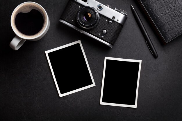 Schreibtisch mit Fotokamera, Kaffee und Notizblock