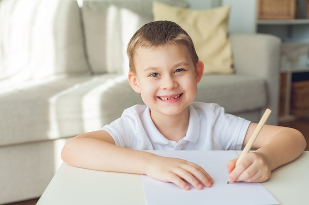 Schüler, der zu Hause auf Papier schreibt.