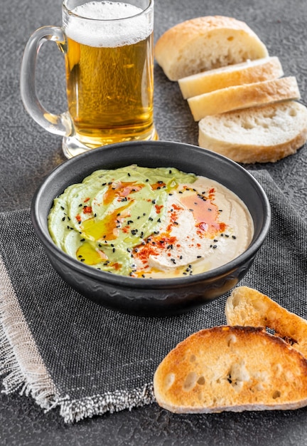 Schüssel Guacamole und Hummus mit geröstetem Brot