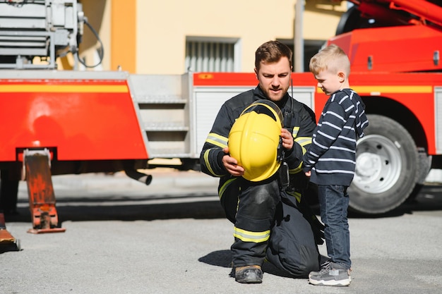 Schützen Sie Menschen mit tapferem Herzen vor gefährlichen Helden in Feuerwehrmann mit einheitlichen sicheren Kindern vor brennendem Rauch