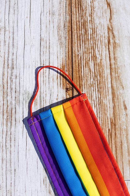 Foto schützende gesichtsmaske gegen covid-19 mit den farben des regenbogens. lgtb. homosexuell lesben. coronavirus-konzept