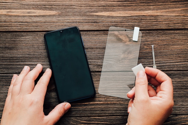 Schützendes undurchdringliches Glas. Vorbereitung zum Aufkleben des Schutzes auf dem Telefondisplay.