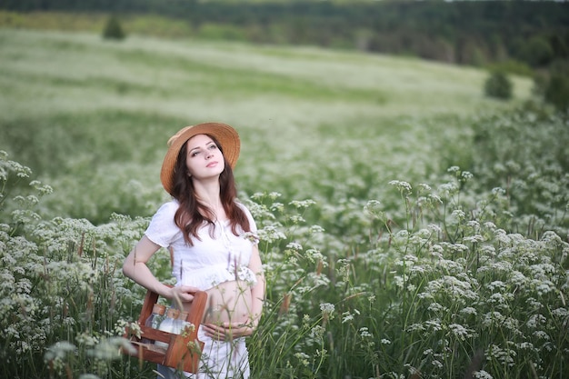 Schwangere Frau in der Natur für einen Spaziergang im Sommer