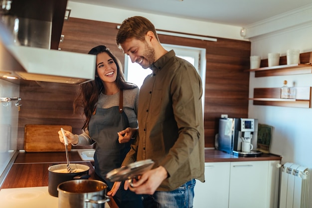 Schwangere Frau und ihr Mann kochen