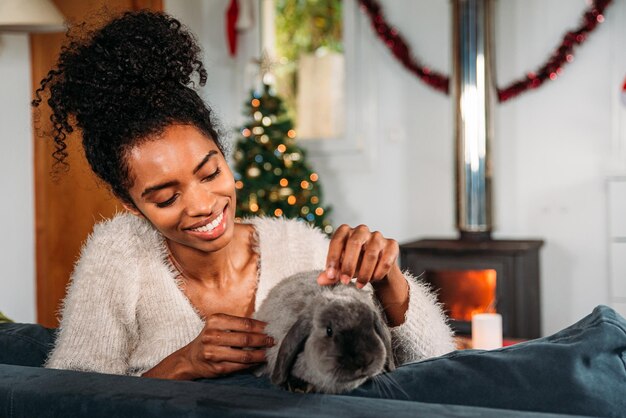 Schwarze Frau mit Kaninchen an Weihnachten