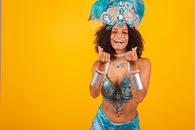 Schwarze Königin der brasilianischen Samba-Schule mit blauer Karnevalskleidung und Federkrone Herz mit den Fingern