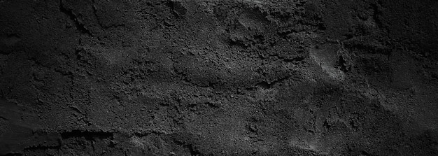 Schwarze Wand beängstigend oder dunkelgrauer, rauer, körniger Steinstrukturhintergrund Schwarzer Beton für den Hintergrund
