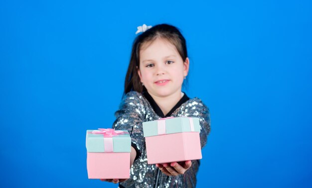 Schwarzer Freitag Einkaufstag Niedliche Kinder tragen Geschenkboxen Überraschungsgeschenkbox Geburtstagswunschliste Welt des Glücks Besonderes passiert jeden Tag Wählen Sie ein Mädchen mit Geschenkboxen blauem Hintergrund