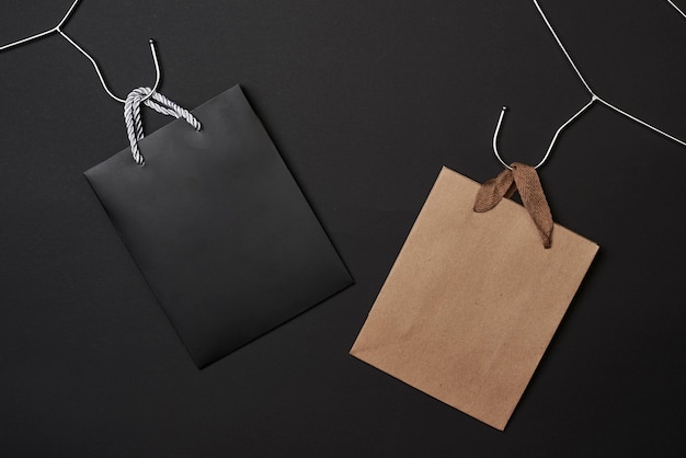 Schwarzer Freitag Konzept schwarz und Bastelpapier Einkaufstüten auf dunklem Hintergrund
