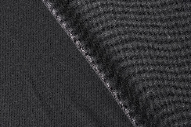 Schwarzer Stoff hautnah als Hintergrund schwarzer Textilhintergrund