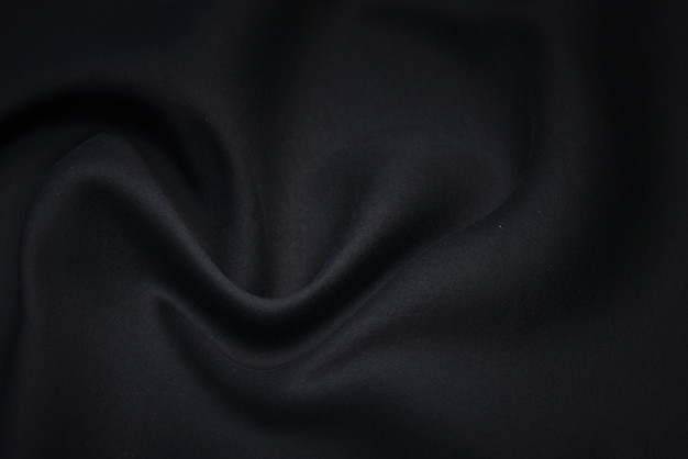 Schwarzer Stoffbeschaffenheitshintergrund. Leeres Luxus-Wafthemd aus Textil und Material.