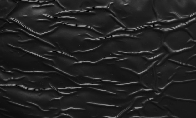 Schwarzer, zerknitterter und zerknitterter Plastikplakat-Texturhintergrund