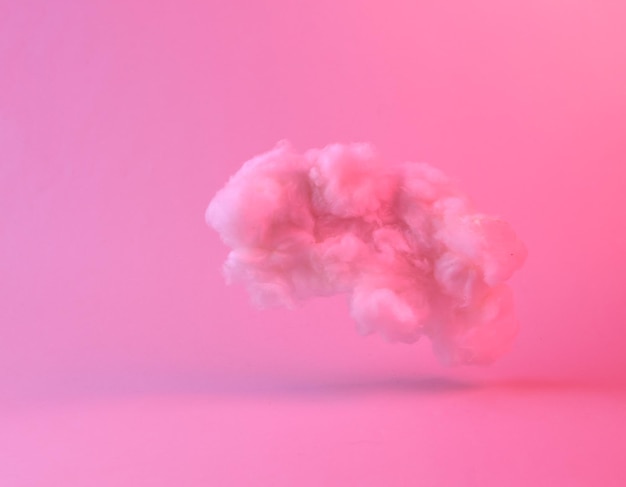 Schwebende, flauschige Wolke in rosa Neon-Gradientenlicht Träume kreative Idee Konzeptkunst Minimalismus