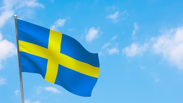 Foto schweden flagge auf pole. blauer himmel. nationalflagge von schweden