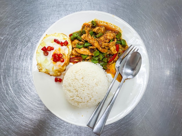 Foto schweinefleisch prik kang gewürzte frische kräuter mit reis