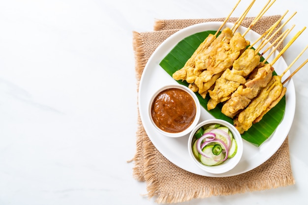 Schweinefleisch-Satay - Gegrilltes Schweinefleisch, serviert mit Erdnusssauce oder süß-saurer Sauce