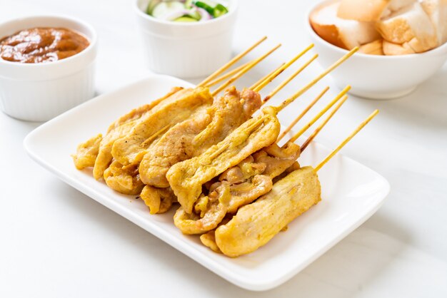 Schweinefleisch-Satay - Gegrilltes Schweinefleisch, serviert mit Erdnusssauce oder süß-saurer Sauce