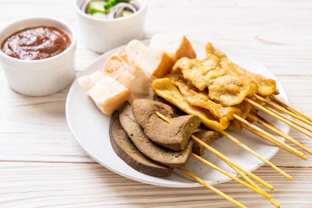 Schweinefleisch Satay mit Erdnusssauce und Gurken