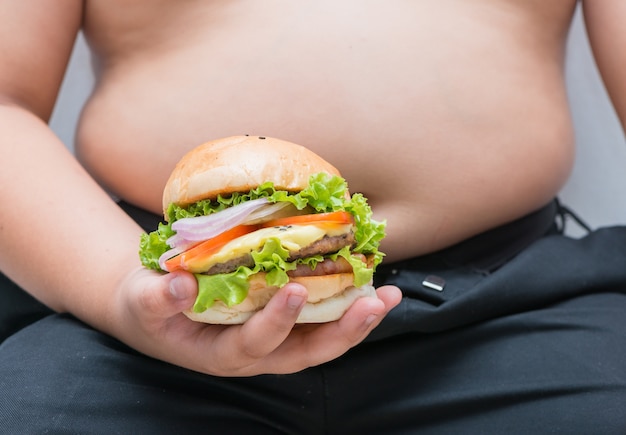 Schweinekäse Hamburger in überladener fetter Jungenhand