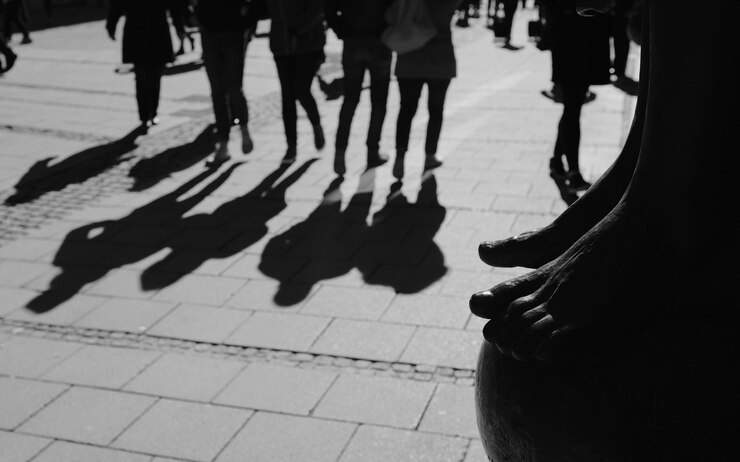 Foto seção baixa de pessoas caminhando na calçada da cidade