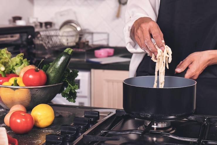 Foto seção média de chef masculino preparando comida na cozinha