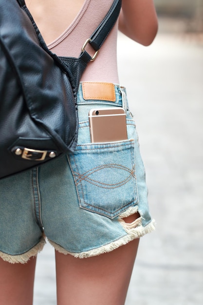 Foto seção média de mulher segurando mochila enquanto está de pé ao ar livre