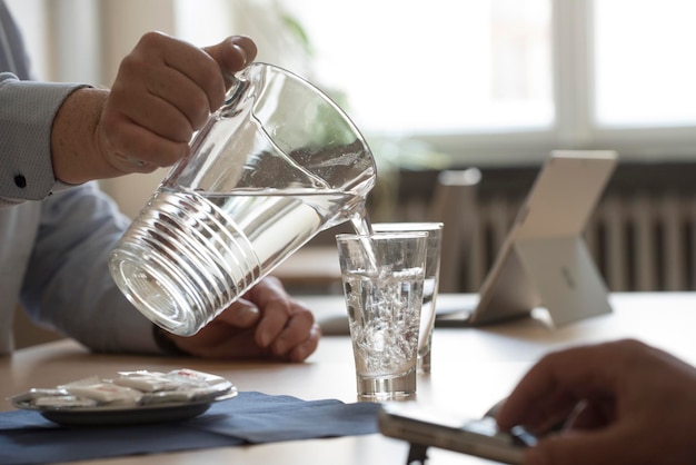 Foto seção média de um homem segurando café na mesa