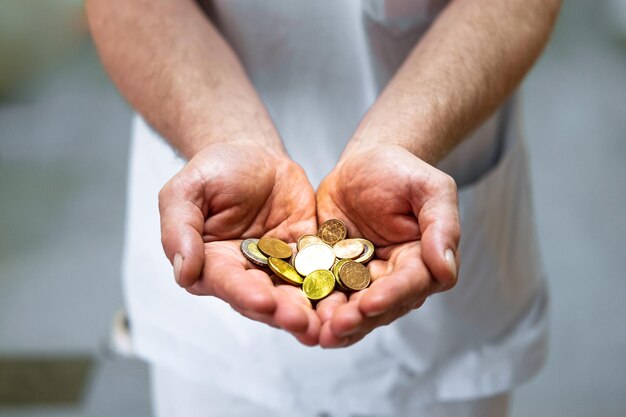 Foto seção média de um homem segurando moedas nas mãos