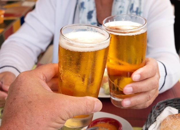 Foto seção média de um homem segurando um copo de cerveja