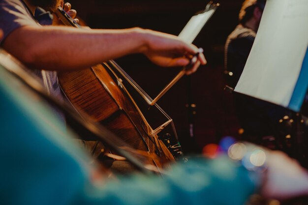 Foto seção média de um homem tocando violoncelo