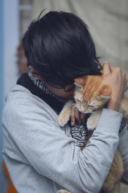 Seção média de uma mulher segurando um gato
