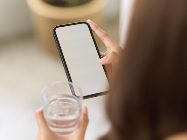 Seção média de uma mulher usando um telefone celular