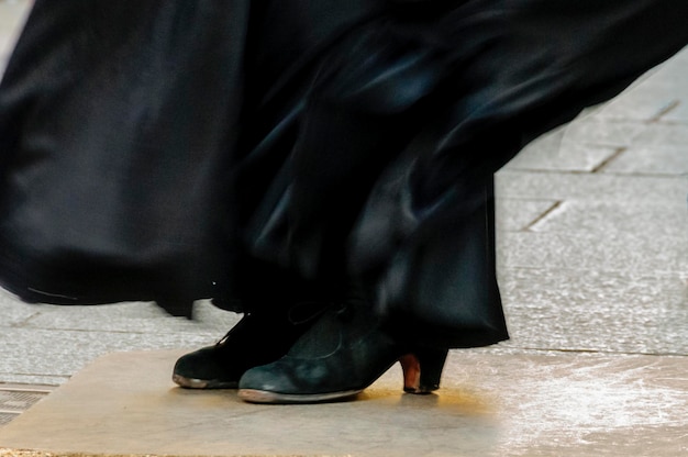 Foto sección baja de mujeres bailando flamenco en la calle