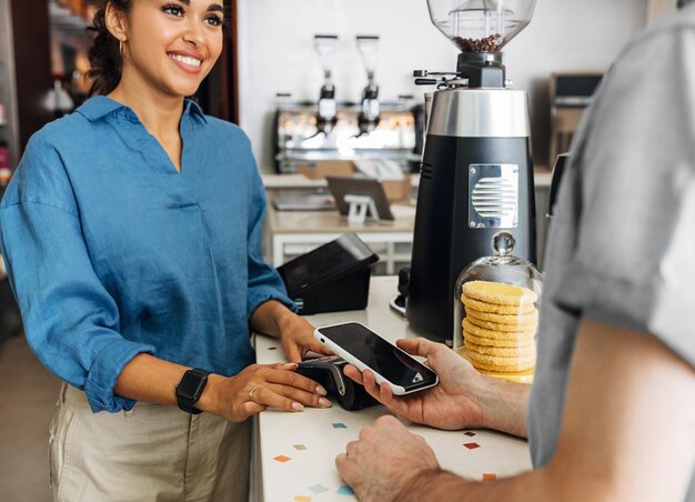 Foto sección media del cliente que hace el pago de nfc en la cafetería