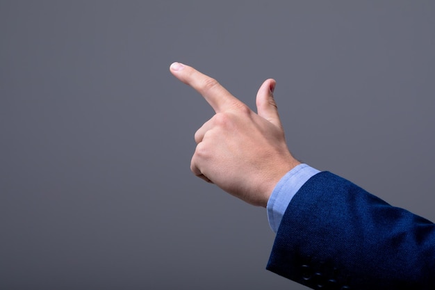 Sección media del hombre de negocios caucásico tocando la interfaz virtual, aislado sobre fondo gris. concepto de tecnología empresarial, comunicación y crecimiento.