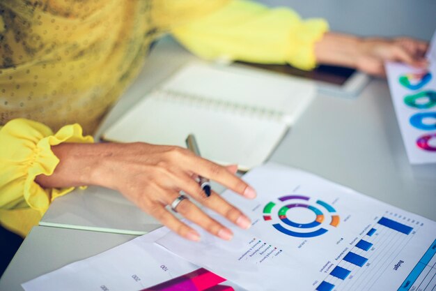 Sección media de una mujer de negocios trabajando sobre un gráfico en la mesa