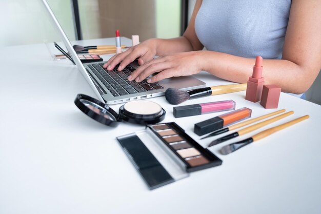 Sección media de una mujer usando una computadora portátil en el escritorio