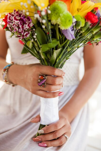 Foto sección media de la novia sosteniendo un ramo colorido