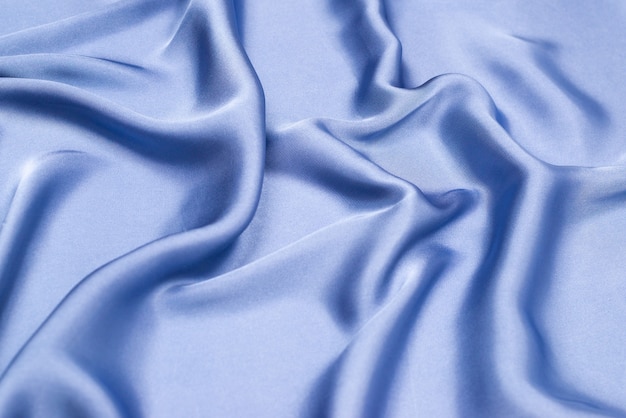Seda azul ou textura de tecido de cetim de luxo. vista do topo.