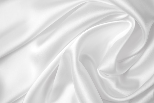 Seda branca elegante suave ou textura de pano de luxo de cetim pode usar como fundo de casamento luxuoso