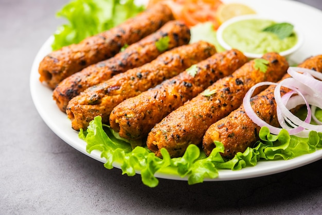 Seekh kabab feito com frango picado ou keema de carneiro, servido com chutney verde e salada