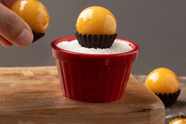 Segurando um delicioso doce brasileiro conhecido como doce baiana Foco seletivo